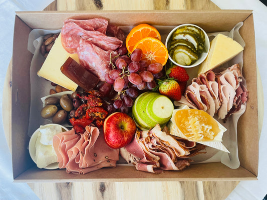 gourmet platter box of artisan farmhouse cheeses, cured meats sliced in house, fresh seasonal fruits and accompanied with Australian olives, pickles, semi dried tomatoes & much more. Complete with sourdough baguette or bread & crackers.